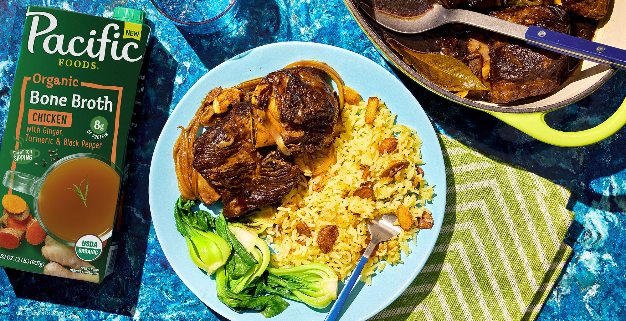 An image of prepared Beef Short Rib Adobo with Sinangag (Filipino Garlic Fried Rice) made with beef short ribs, onion, garlic, soy sauce, Pacific Foods® Organic Chicken Bone Broth with Ginger, Turmeric and Black Pepper and jasmine rice.