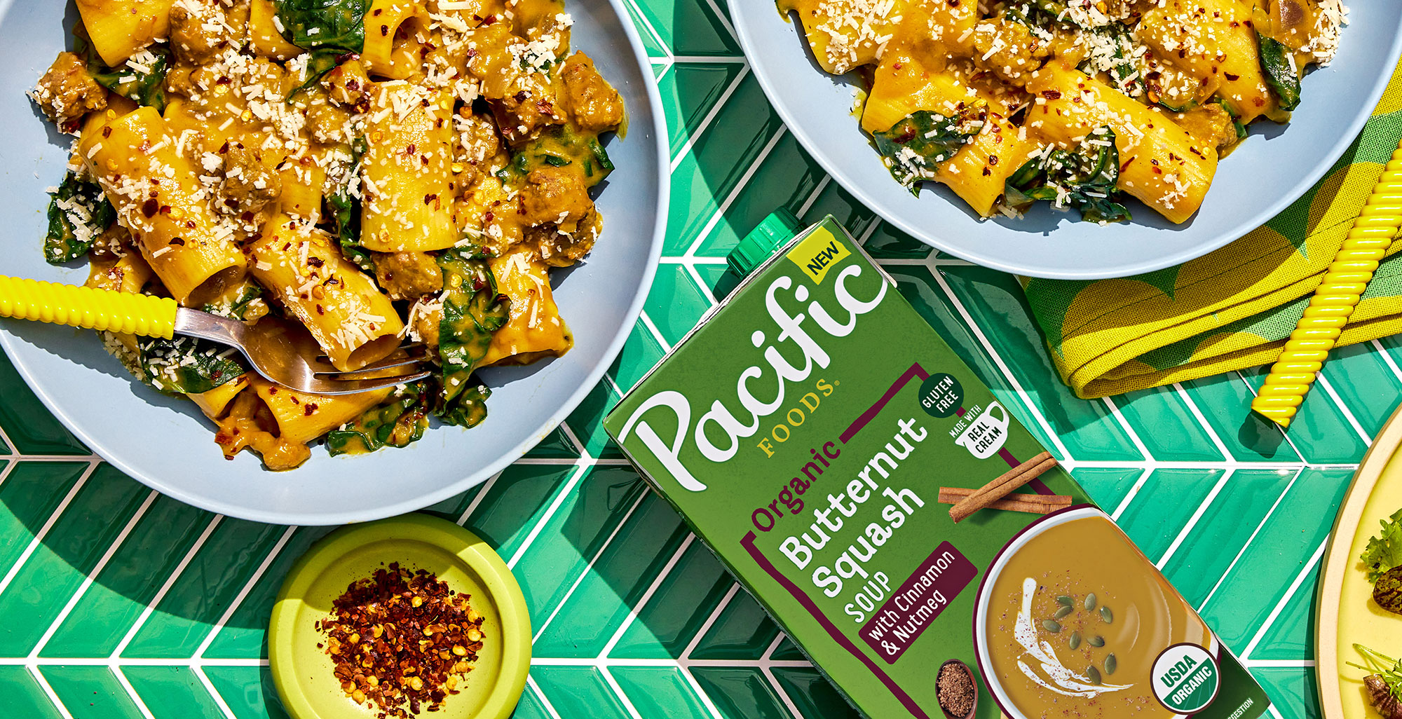 An image of prepared Butternut Squash and Sausage Rigatoni made with pork sausage, red onion, Pacific Foods® Organic Butternut Squash Soup with Cinnamon and Nutmeg, rigatoni, kale, Gruyére cheese and Parmesan.