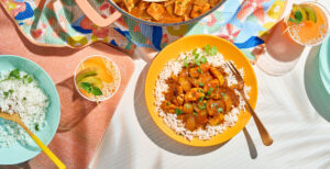 An image of prepared Caribbean Coconut Chicken with Rice made with rice, chicken, onion, bell pepper, jalapeño pepper, Pacific Foods® Organic Condensed Tomato Soup and Pacific Foods® Organic Coconut Unsweetened Organic Beverage and cilantro.
