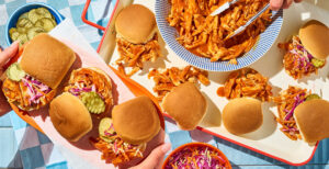 An image of prepared Slow Cooker Hot Honey BBQ Chicken Sliders made with chicken, Pacific Foods® Organic Condensed Tomato Soup and Pepperidge Farm® White Slider Buns.