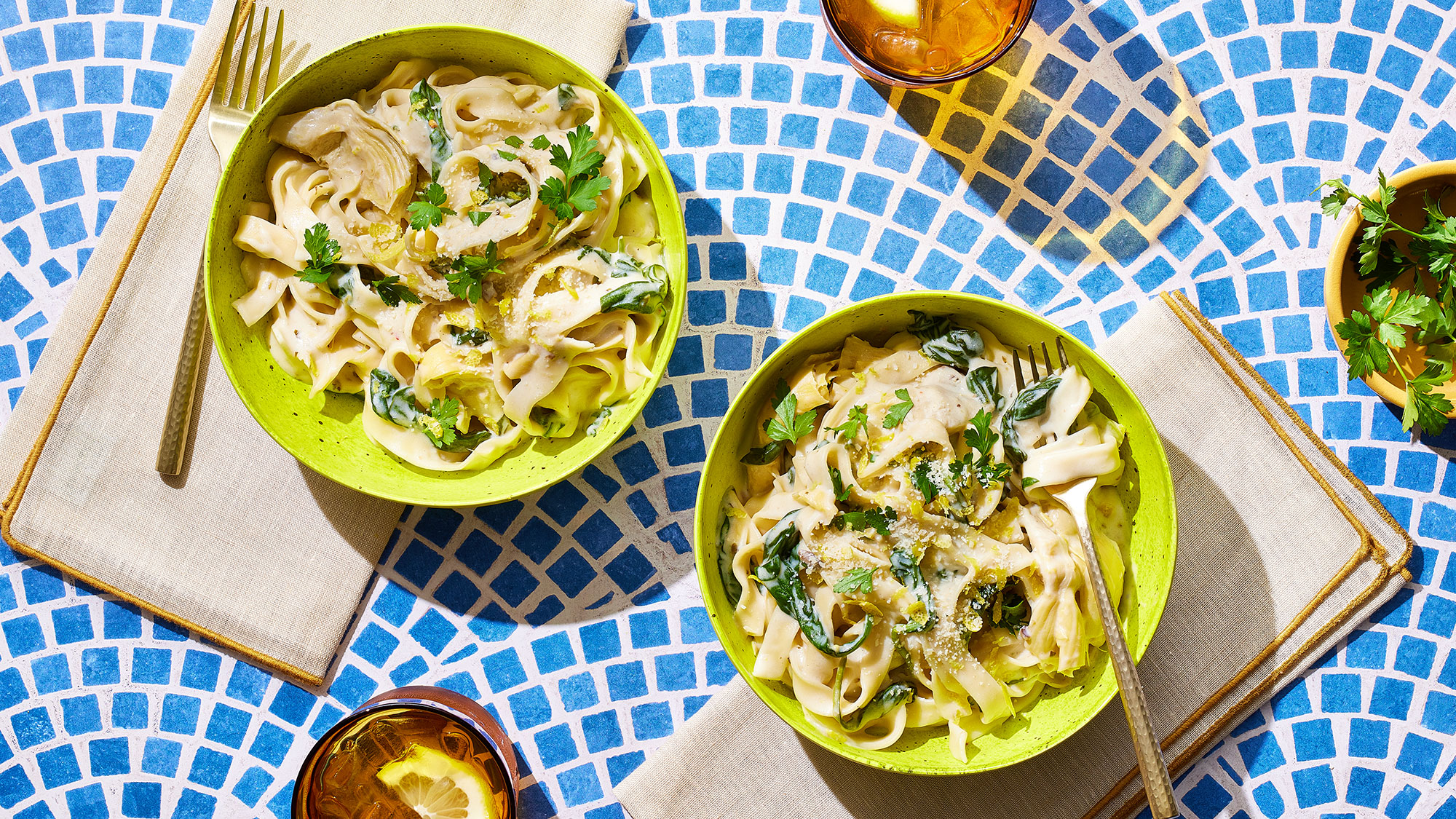 An image of prepared Creamy Spinach and Artichoke Dip Pasta made with pasta, garlic, baby spinach, artichoke hearts, Pacific Foods® Organic Cream of Mushroom Condensed Soup, cream cheese and Parmesan.