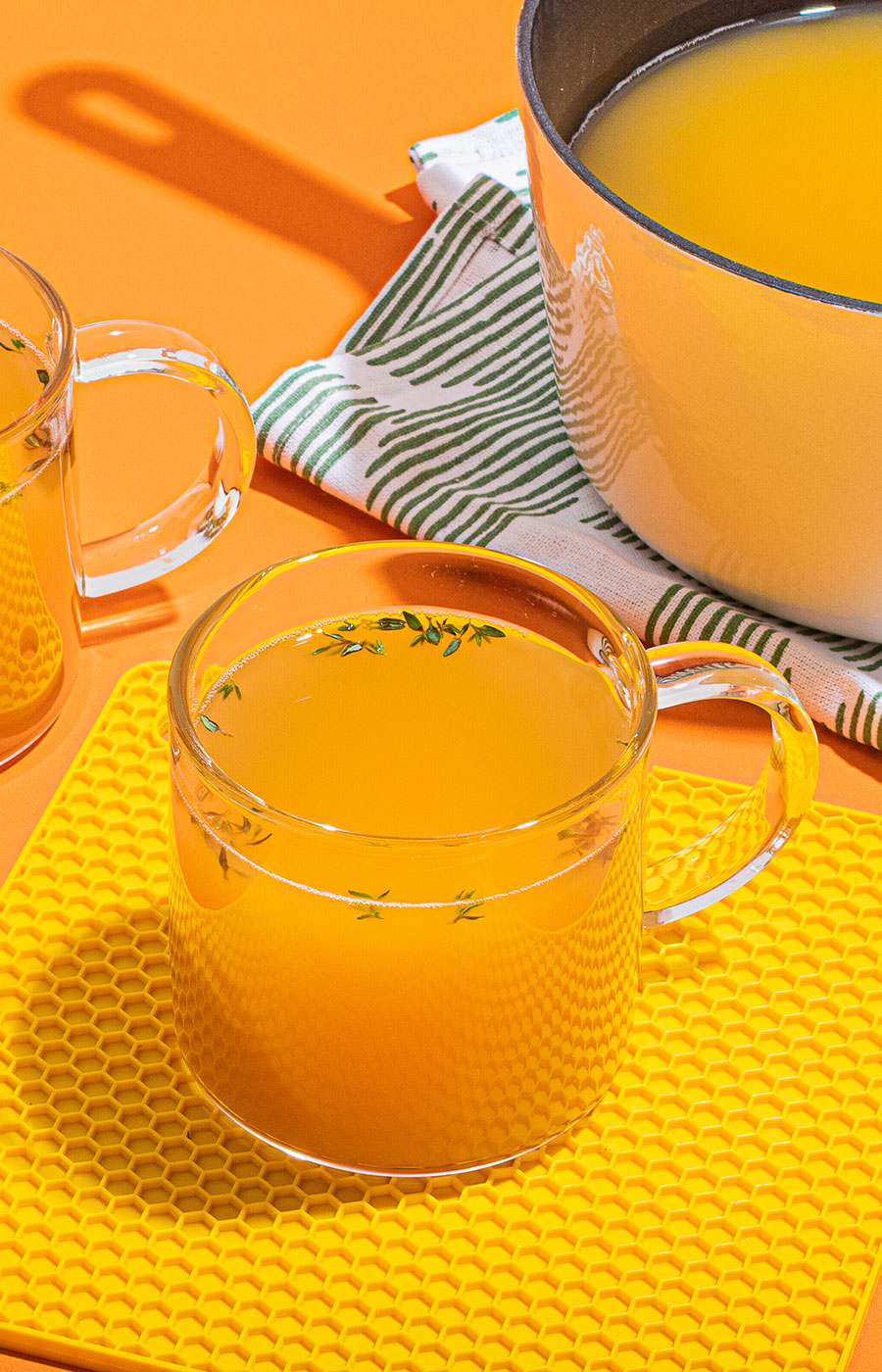 An image of prepared Lemon & Ginger Chicken Bone Broth Toddy made with Pacific Foods® Organic Unsalted Chicken Bone Broth, ginger, garlic, herbs and honey.