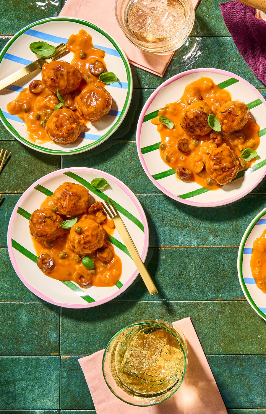 An image of prepared Turkey Meatball Bites with Creamy Puttanesca Sauce made with ground turkey, Pacific Foods® Organic Spicy Garden Tomato Soup, basil, onion, kalamata olives, capers and balsamic vinegar.