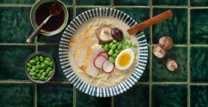 An image of prepared Chicken Miso Ramen made with eggs, ramen noodles, Pacific Foods® Organic Chicken Miso Ramen Broth, chicken, edamame, corn, green onion and radish.