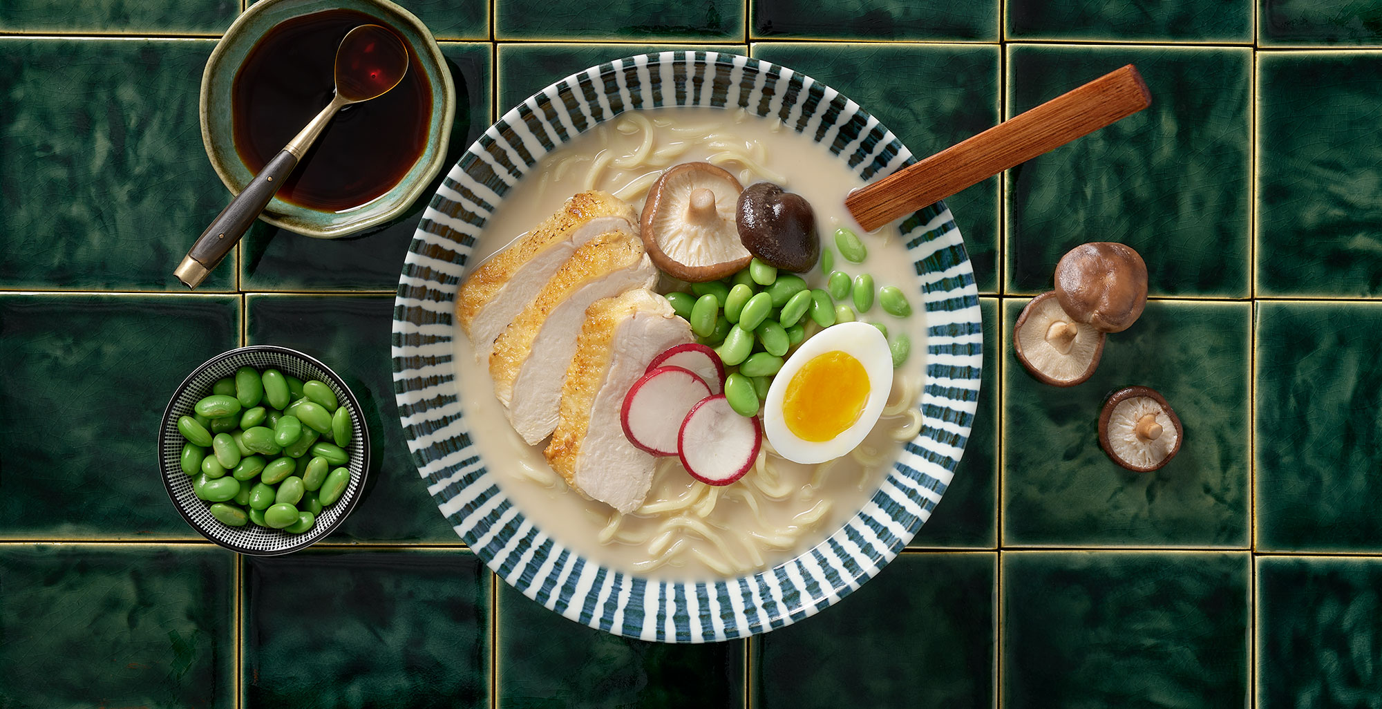An image of prepared Chicken Miso Ramen made with eggs, ramen noodles, Pacific Foods® Organic Chicken Miso Ramen Broth, chicken, edamame, corn, green onion and radish.