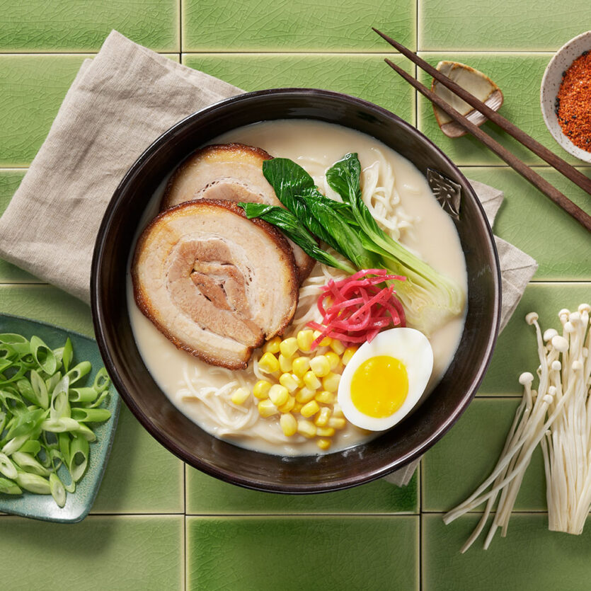 An image of prepared Pork Tonkotsu Ramen made with eggs, ramen noodles, Pacific Foods® Organic Pork Tonkotsu Ramen Broth, pork tenderloin, bok choy, ginger, green onion and shiitake mushrooms.