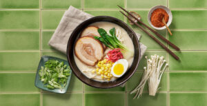 An image of prepared Pork Tonkotsu Ramen made with eggs, ramen noodles, Pacific Foods® Organic Pork Tonkotsu Ramen Broth, pork tenderloin, bok choy, ginger, green onion and shiitake mushrooms.