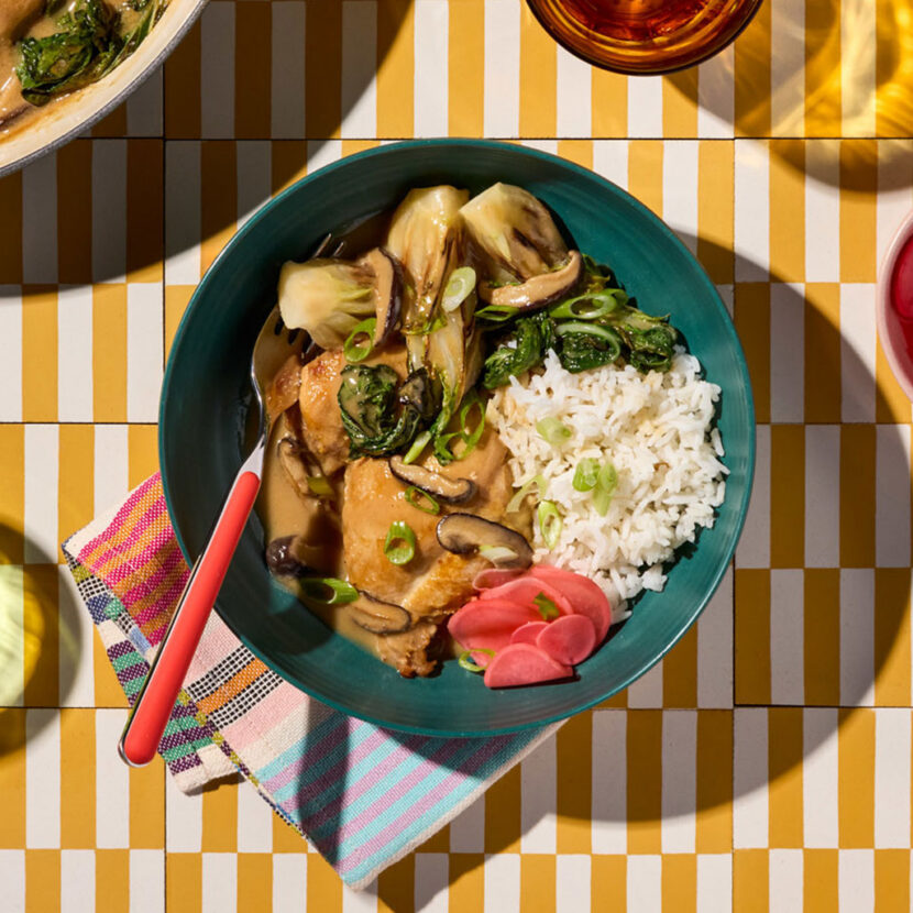 An image of prepared Braised Miso Chicken with Shiitakes and Baby Bok Choy made with chicken thighs, shiitake mushrooms, baby bok choy, Pacific Foods® Organic Chicken Miso Ramen Broth and rice.