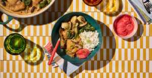 An image of prepared Braised Miso Chicken with Shiitakes and Baby Bok Choy made with chicken thighs, shiitake mushrooms, baby bok choy, Pacific Foods® Organic Chicken Miso Ramen Broth and rice.