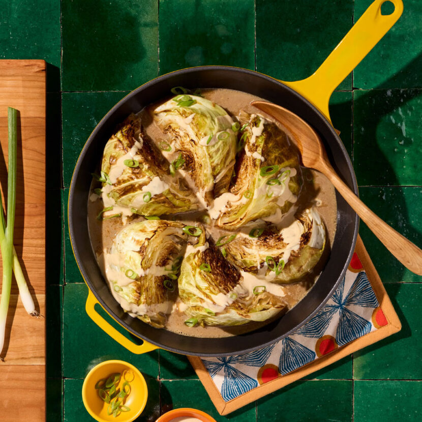 An image of prepared Miso Braised Cabbage with Lemon-Tahini Drizzle made with green cabbage, Pacific Foods® Organic Chicken Miso Ramen Broth, tahini paste, lemon juice and maple syrup.