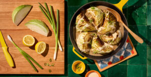 An image of prepared Miso Braised Cabbage with Lemon-Tahini Drizzle made with green cabbage, Pacific Foods® Organic Chicken Miso Ramen Broth, tahini paste, lemon juice and maple syrup.